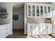 Bright kitchen cabinets with glass fronts and mosaic backsplash, with light shining on the wood flooring at 11520 Shipwatch Dr # 1385, Largo, FL 33774