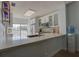 Modern kitchen featuring white cabinets, stainless steel appliances, and a breakfast bar with ample counter space at 11520 Shipwatch Dr # 1385, Largo, FL 33774