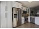 Modern kitchen boasts stainless steel appliances, white cabinetry, and stylish backsplash at 11520 Shipwatch Dr # 1385, Largo, FL 33774