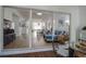 View from enclosed balcony looking into the open-concept living room, dining area, and kitchen at 11520 Shipwatch Dr # 1385, Largo, FL 33774