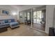 Inviting living space featuring a blue couch and an outdoor lanai with seating through sliding glass doors at 11520 Shipwatch Dr # 1385, Largo, FL 33774