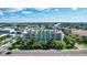 Aerial view of a condo surrounded by lush green landscaping at 11605 Gulf Blvd # 203, Treasure Island, FL 33706
