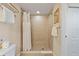 Bathroom featuring a tiled shower with shower curtain and a toilet at 11605 Gulf Blvd # 203, Treasure Island, FL 33706