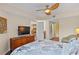 Bedroom with TV and access to bathroom and kitchen spaces. Modern and functional design at 11605 Gulf Blvd # 203, Treasure Island, FL 33706