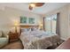 Cozy bedroom with a starfish-themed bedspread, artistic wall decor, and a sliding glass door to the patio at 11605 Gulf Blvd # 203, Treasure Island, FL 33706