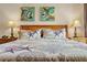 Well-lit primary bedroom features a starfish-themed bedspread, coastal decor, and matching lamps at 11605 Gulf Blvd # 203, Treasure Island, FL 33706