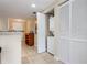 Hallway featuring laundry closet, storage, neutral tones and tiled floors at 11605 Gulf Blvd # 203, Treasure Island, FL 33706