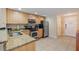 Functional kitchen design with granite countertops and stainless steel appliances near the entry at 11605 Gulf Blvd # 203, Treasure Island, FL 33706