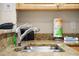 Close up of the stainless steel kitchen sink with granite countertops at 11605 Gulf Blvd # 203, Treasure Island, FL 33706