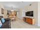 Open living space featuring tile floors, modern furniture, and a TV at 11605 Gulf Blvd # 203, Treasure Island, FL 33706