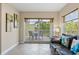 Cozy living room boasting sliding glass doors to the patio, tile floors, and stylish decor at 11605 Gulf Blvd # 203, Treasure Island, FL 33706