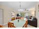 Open-concept living space with dining area, access to bedroom, and a balcony at 11605 Gulf Blvd # 203, Treasure Island, FL 33706