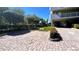 A well-maintained parking area with a brick-paved surface, landscaped greenery, and nearby parking spaces at 11605 Gulf Blvd # 203, Treasure Island, FL 33706