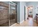 Bathroom showcasing a glass shower and an open doorway to the main bedroom at 12107 Rambling Stream Dr, Riverview, FL 33569