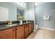Spacious bathroom with double sinks, granite countertops, and neutral tile floors at 12107 Rambling Stream Dr, Riverview, FL 33569
