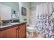 Bathroom features dark granite countertops and a shower with a decorative curtain at 12107 Rambling Stream Dr, Riverview, FL 33569