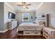 Cozy bedroom featuring modern rustic furniture, wood-look flooring and a ceiling fan at 12107 Rambling Stream Dr, Riverview, FL 33569