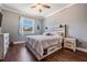 Cozy bedroom featuring modern rustic furniture, wood-look flooring and a ceiling fan at 12107 Rambling Stream Dr, Riverview, FL 33569