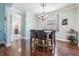 Beautiful dining room with modern chandelier, dark hardwood floors, and an archway entrance at 12107 Rambling Stream Dr, Riverview, FL 33569