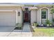 Inviting front entryway with a covered porch and landscaped walkway leading to the front door at 12107 Rambling Stream Dr, Riverview, FL 33569