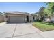 Exterior view of a home with an attached two-car garage and well-kept lawn at 12107 Rambling Stream Dr, Riverview, FL 33569