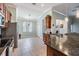 Contemporary kitchen with stone countertops, stainless steel appliances, and open to dining area at 12107 Rambling Stream Dr, Riverview, FL 33569