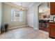 Bright eat-in kitchen features light-colored tile flooring and chandelier lighting at 12107 Rambling Stream Dr, Riverview, FL 33569