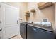 Laundry room featuring tile flooring and modern washer and dryer at 12107 Rambling Stream Dr, Riverview, FL 33569