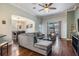 Comfortable living room with hardwood floors, neutral paint, and large windows to view the neighborhood at 12107 Rambling Stream Dr, Riverview, FL 33569