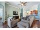 Open-concept living area with hardwood floors, neutral paint, and easy access to the kitchen at 12107 Rambling Stream Dr, Riverview, FL 33569