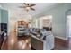 Spacious living room features dark hardwood floors, a ceiling fan, and an open floor plan at 12107 Rambling Stream Dr, Riverview, FL 33569