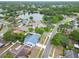 An aerial view of a neighborhood highlighting a home with a private pool near a scenic lake at 1213 Callista Ave, Valrico, FL 33596