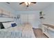 Bedroom featuring a large bed, laminate flooring, and white closet doors at 1213 Callista Ave, Valrico, FL 33596