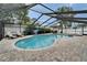 Sparkling blue pool and spa, with ample dining and lounging space in a screened enclosure at 1213 Callista Ave, Valrico, FL 33596