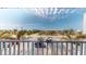 Enjoy the neighborhood view from the balcony, with lush palm trees and clear blue skies above at 12405 3Rd E St # 306, Treasure Island, FL 33706