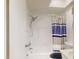 Clean, tiled bathroom features a shower with adjustable head, skylight and blue-striped curtain at 12405 3Rd E St # 306, Treasure Island, FL 33706