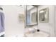 Bathroom sink and decorative mirror with a view of a part of the shower are present in the image at 12405 3Rd E St # 306, Treasure Island, FL 33706