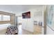Bright bedroom with a flatscreen TV and sliding glass doors leading to a sunroom with water views at 12405 3Rd E St # 306, Treasure Island, FL 33706