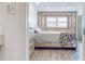 Bright bedroom featuring a comfy bed, wood dresser, and cinderblock accents near a double-hung window at 12405 3Rd E St # 306, Treasure Island, FL 33706