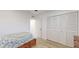 Cozy bedroom with wood-look floors, closet, and a comfortable bed at 12405 3Rd E St # 306, Treasure Island, FL 33706
