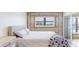 Cozy bedroom featuring a comfy bed, bright windows, and a modern sliding glass door at 12405 3Rd E St # 306, Treasure Island, FL 33706