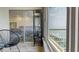 Bedroom scene including a water view, glass cabinet, and slider leading to sun room at 12405 3Rd E St # 306, Treasure Island, FL 33706