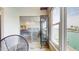 View of a Bedroom scene including a water view, glass cabinet, and slider leading to sun room at 12405 3Rd E St # 306, Treasure Island, FL 33706