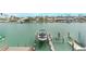 An elevated aerial shot of a boat lift and boats on beautiful turquoise water at 12405 3Rd E St # 306, Treasure Island, FL 33706
