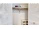 White, shuttered closet with shelves and open storage provides ample space for clothing and personal items at 12405 3Rd E St # 306, Treasure Island, FL 33706