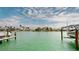 Waterfront boat dock featuring turquoise water and clear blue skies at 12405 3Rd E St # 306, Treasure Island, FL 33706
