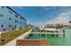 Outdoor patio next to the boat dock overlooking the clear water and boats, on a sunny day at 12405 3Rd E St # 306, Treasure Island, FL 33706