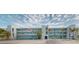 Exterior of a light blue condo building featuring balconies and palm trees in a sunny neighborhood at 12405 3Rd E St # 306, Treasure Island, FL 33706