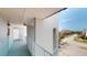 A well-lit hallway with blue floors and white trim leads to the units of the condo building at 12405 3Rd E St # 306, Treasure Island, FL 33706