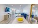 Spacious living room with stylish decor, wood-look floors, and ample natural light at 12405 3Rd E St # 306, Treasure Island, FL 33706